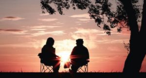Couple sitting at sunset