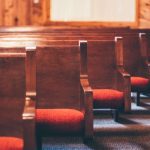 Red seated traditional church pews in a line