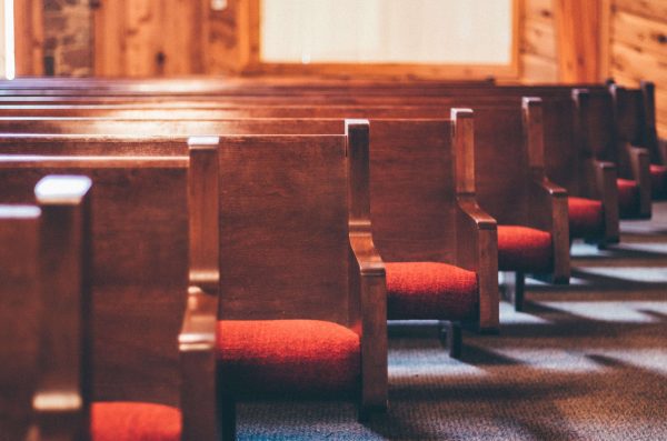 Red seated traditional church pews in a line