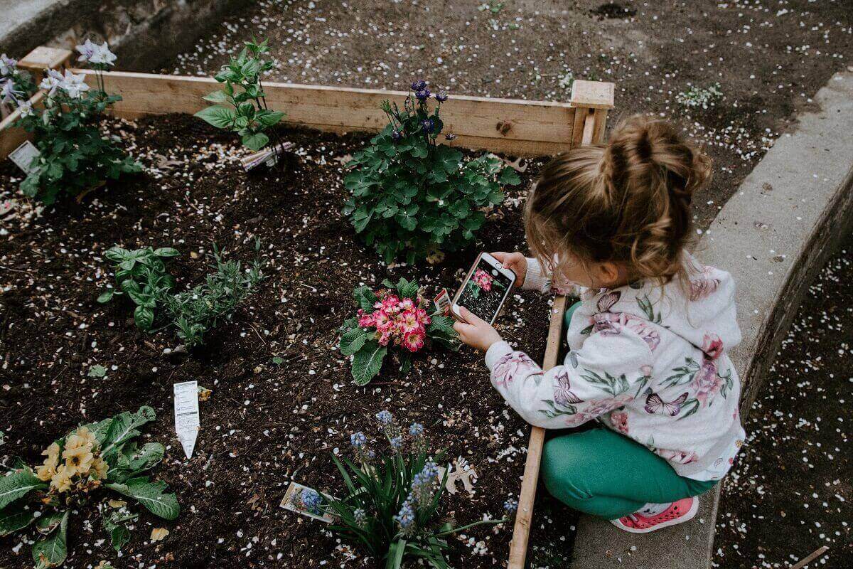 Child Planting in Garden
